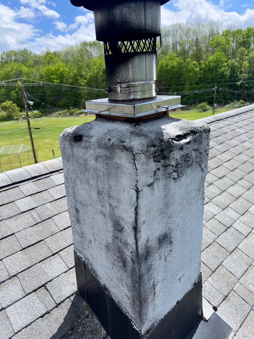 Sooty, cracked chimney crown before repair