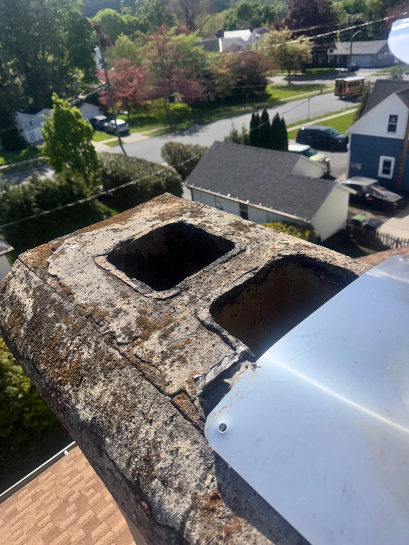 Old cracked chimney crown, uncapped and exposed