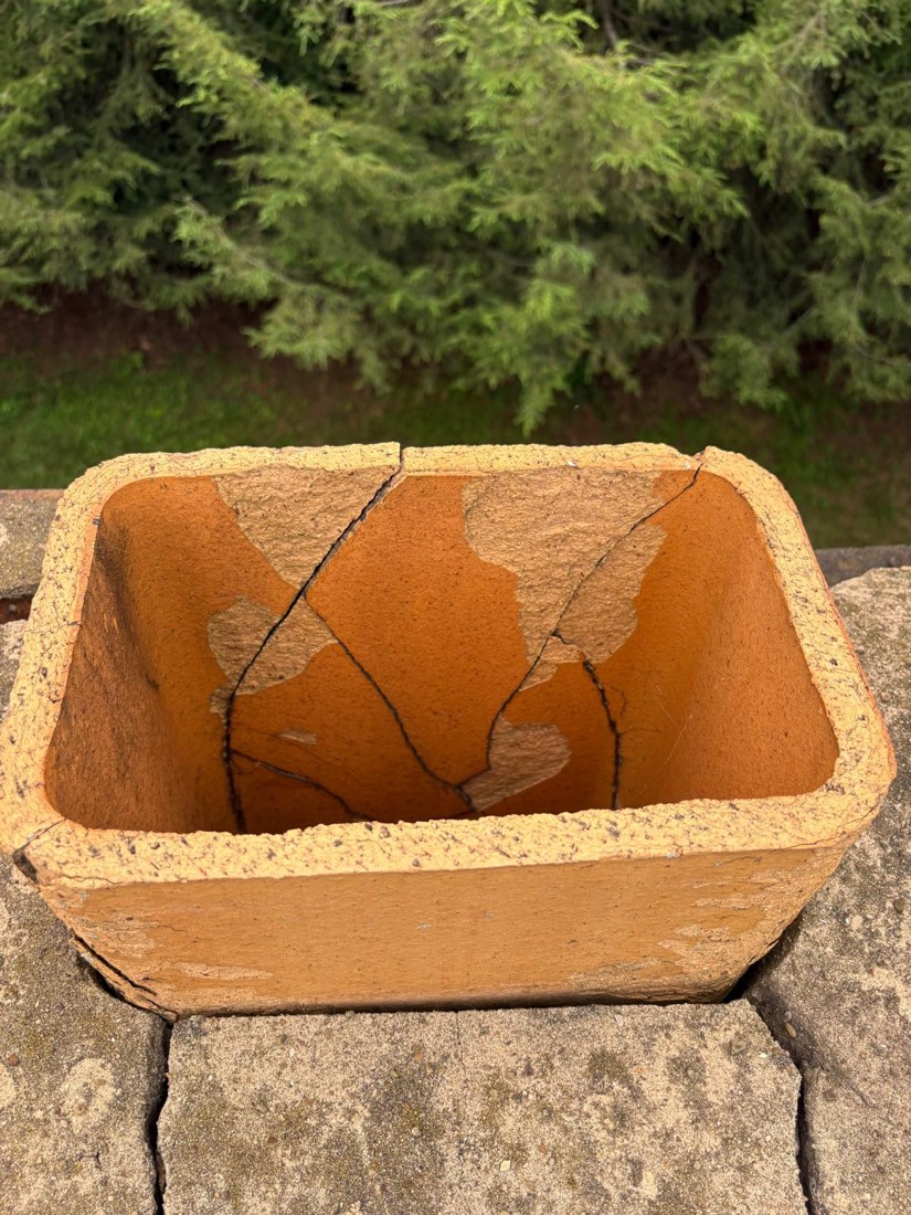 Cracked clay flue tile inside a chimney