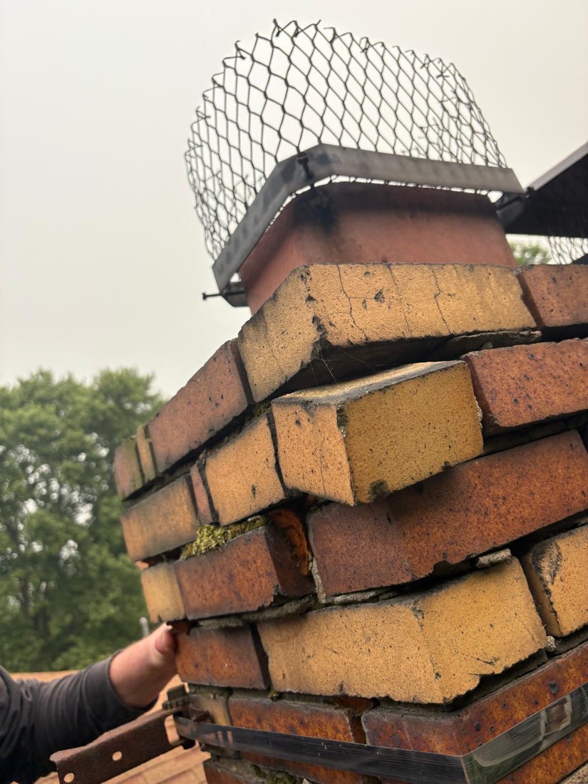 A chimney brick pulled loose by hand, showing completely failed mortar